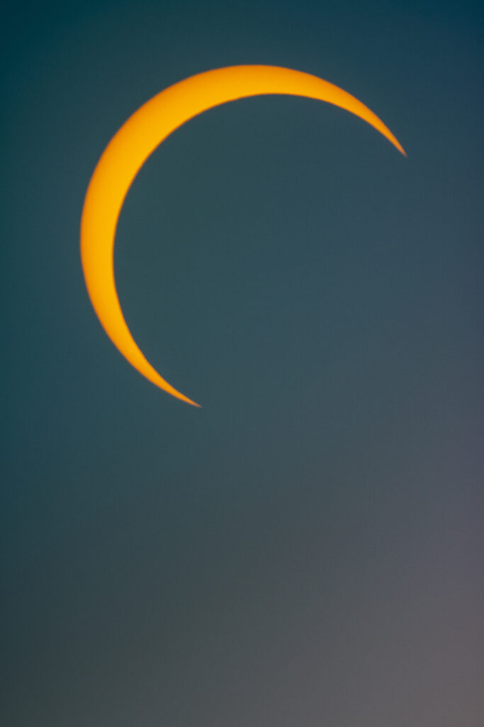 A picture of a partial moon during a solar eclipse.